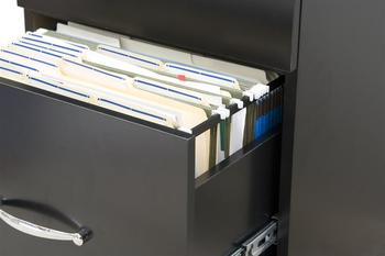 black cabinet with opened drawer with files in folders