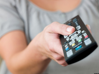 A woman pointing a remote control