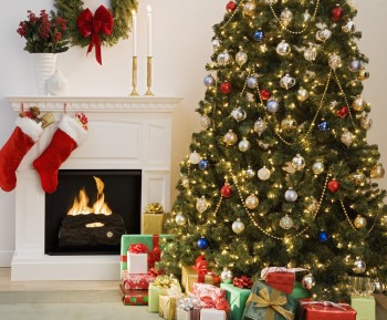 Christmas tree with presents and fireplace with stockings --- Image by © Royalty-Free/Corbis