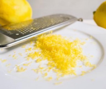 Close-Up Of Lemon Zest And Grater In Plate